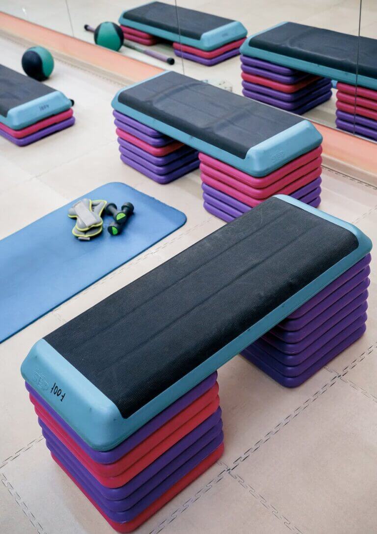 aerobic step platform an mat placed on floor in gym