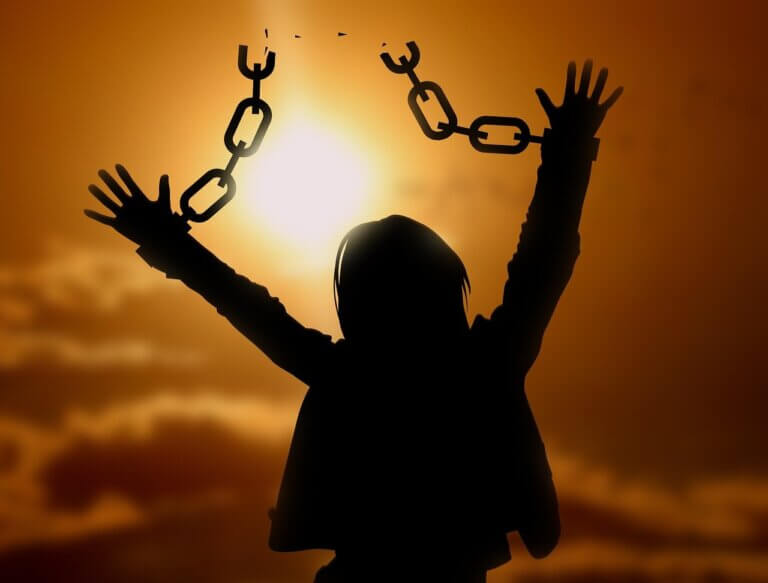 My eating disorder story, freedom, silhouette, a woman breaking out of chains