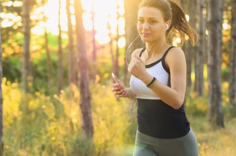 woman, jogging in forest, wearing black and white tank top