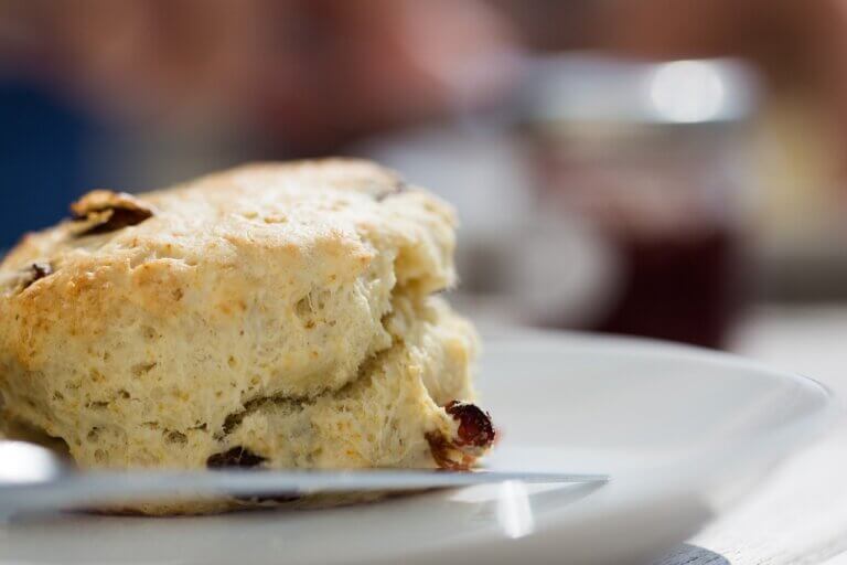 Baked scone on a white plate with blurred background