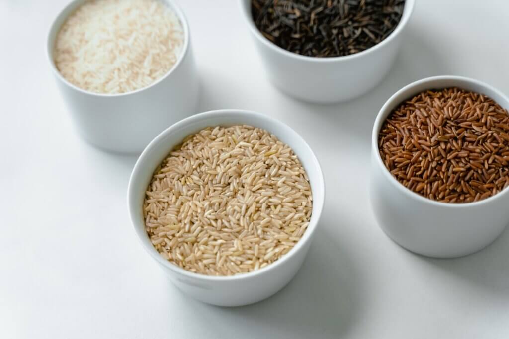 Close-Up of Variety of White, Black, Red and Brown Rice in Small White Bowls