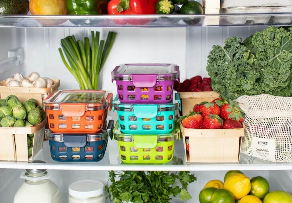 Inside of refrigertor, fresh vegetables, and colorful containers