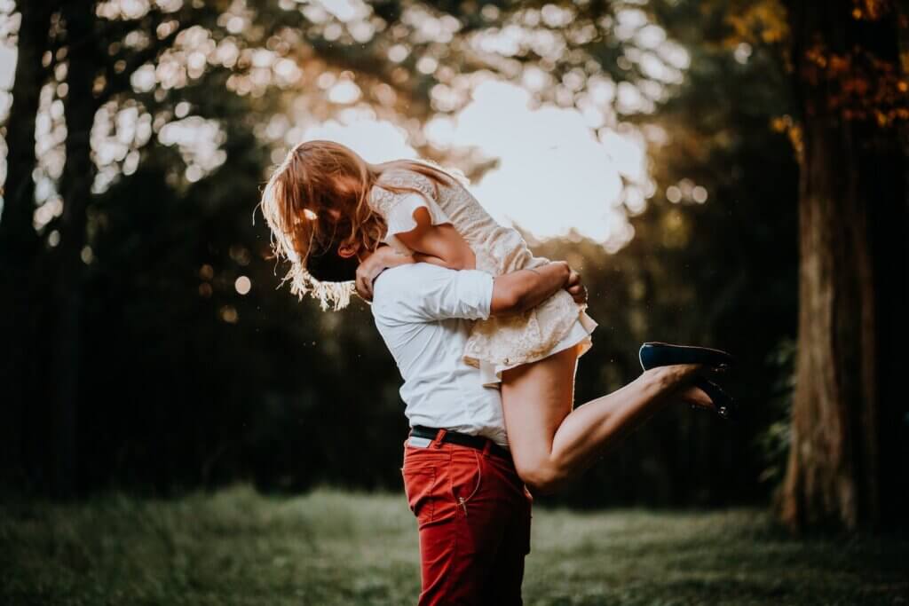 Woman Jumps into a Mans Arms in a Park